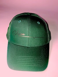 a green hat with the word vine on it