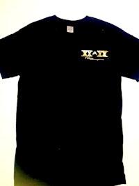 a black t - shirt with a gold logo on it