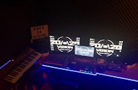 a recording studio with two monitors and a keyboard