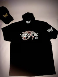 a black t - shirt and hat with the word wwe on it